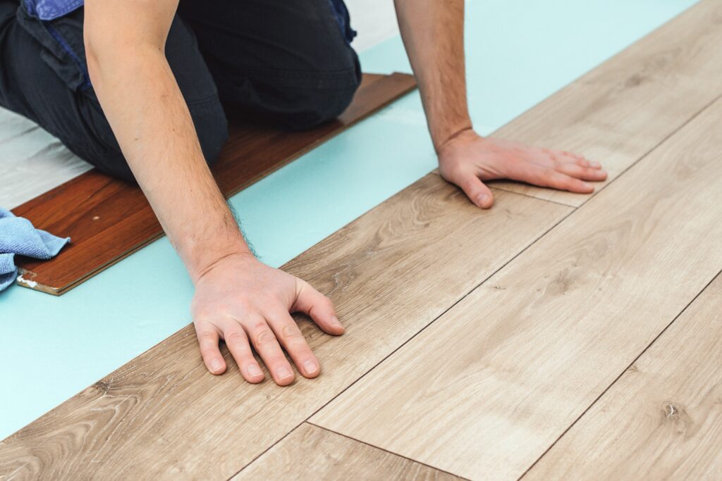 man performing professional hardwood flooring installation