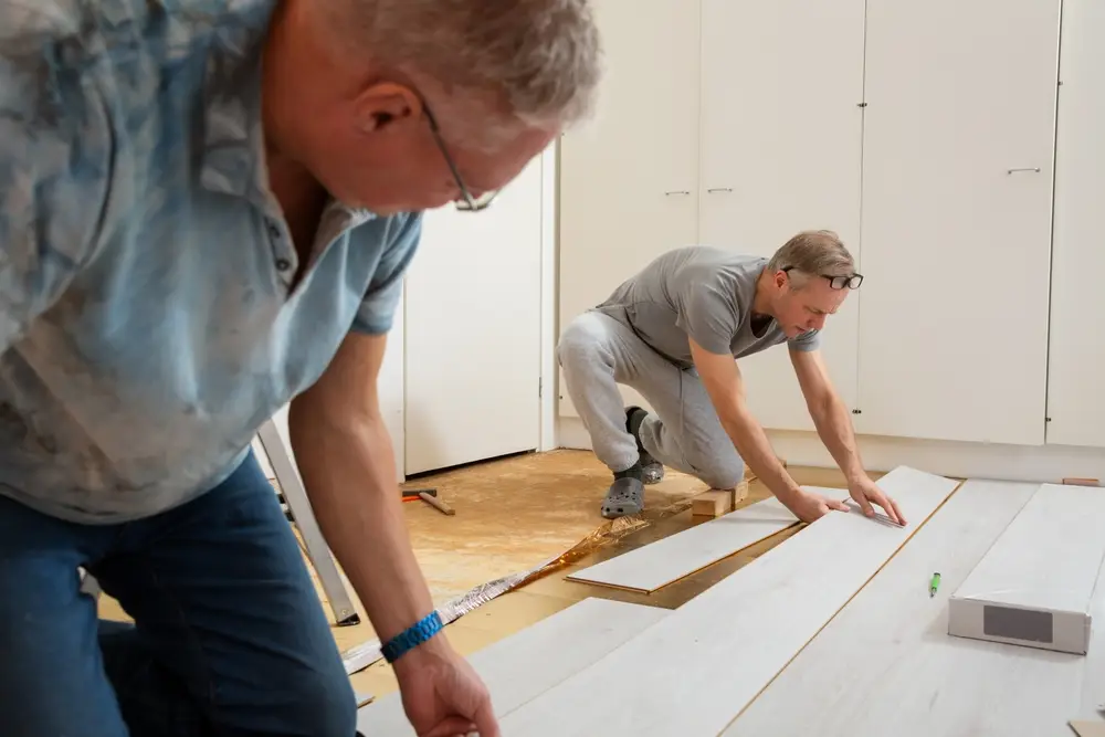 two guys performing laminate flooring installation